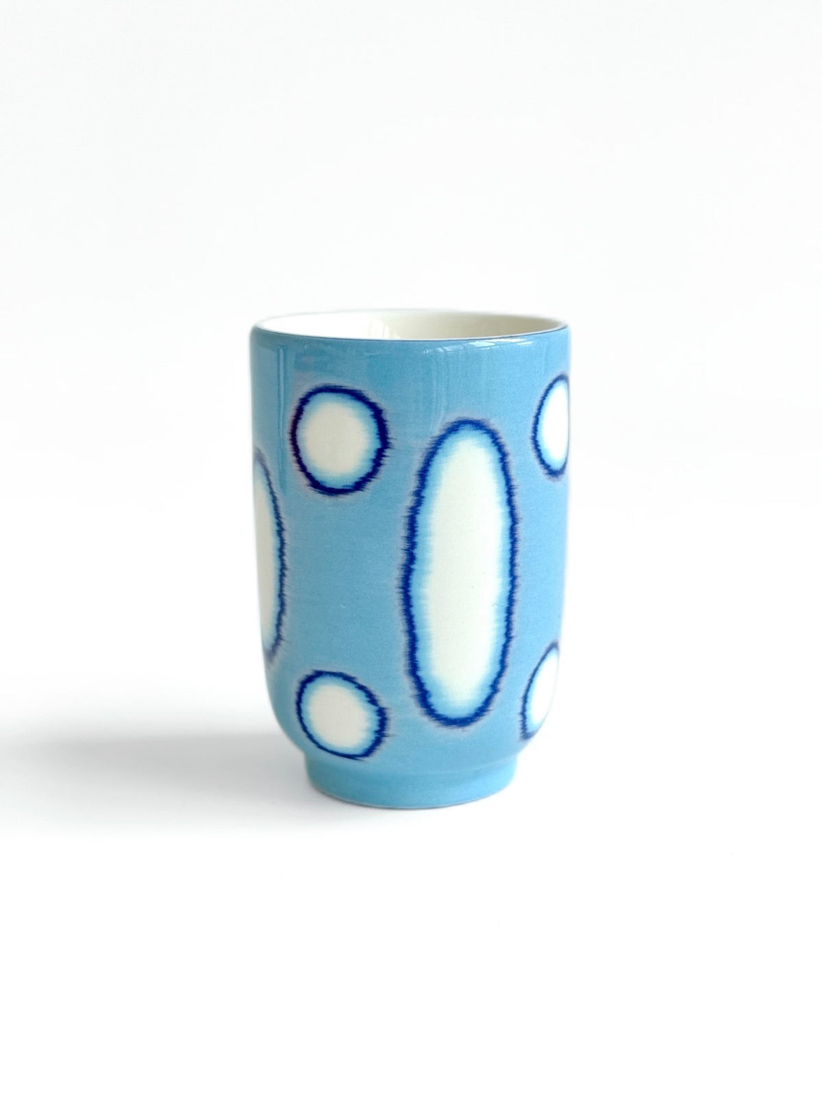 Light blue ceramic tea cup with navy blue circle and oval outline pattern, TalkFun collection