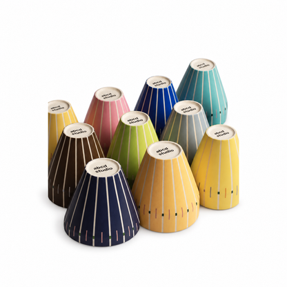 Set of ten Linework ceramic tumblers by abcd studio in assorted colors with hand-painted vertical line pattern