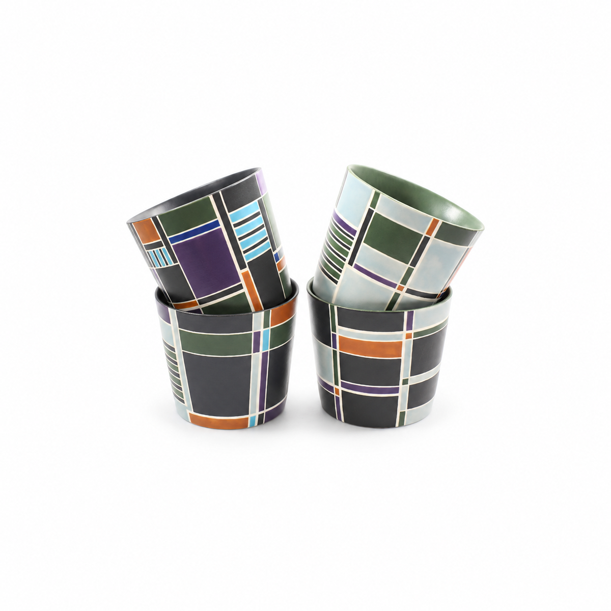 Four stacked Linework geometric ceramic cups by abcd studio in assorted colorways