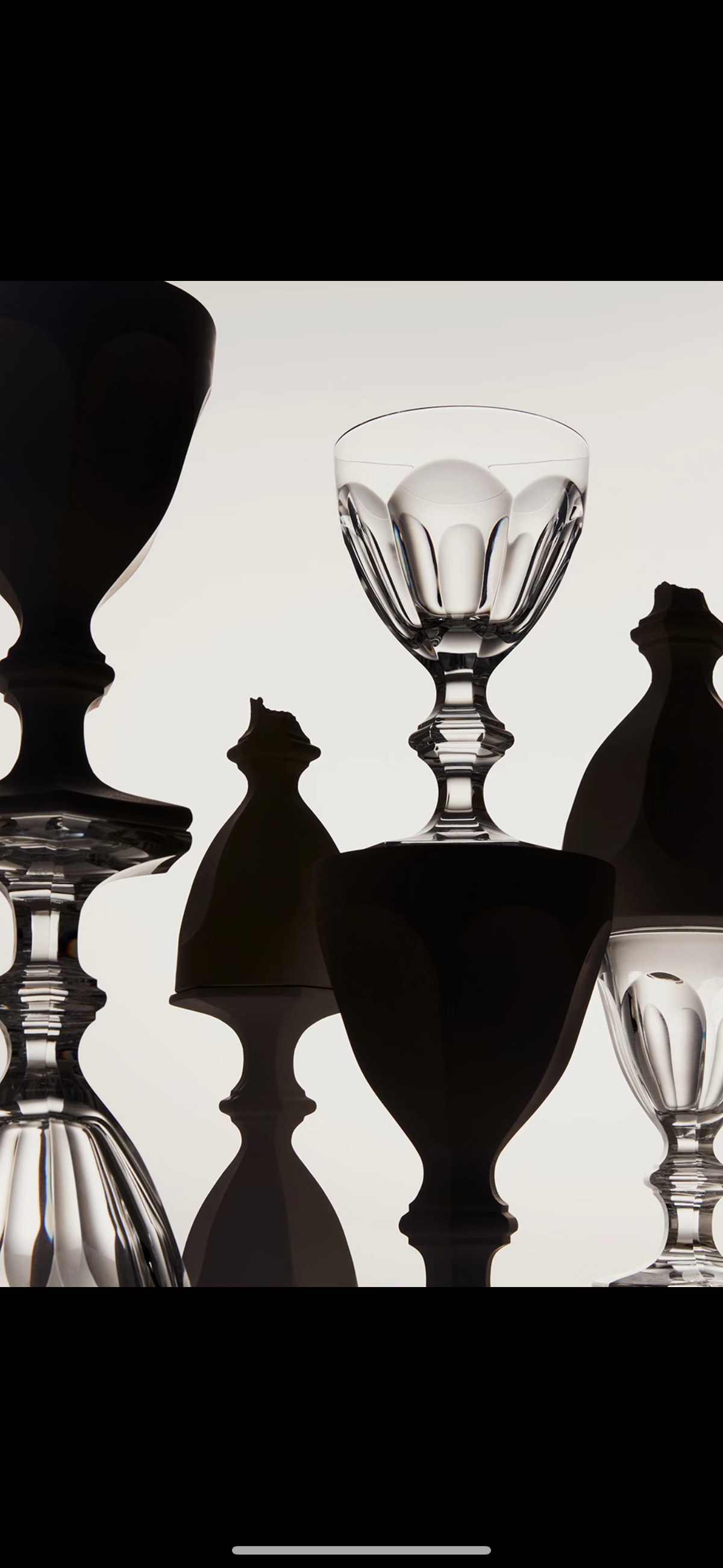 Dark, glossy sculptural ceramic vases and goblets with silhouetted forms