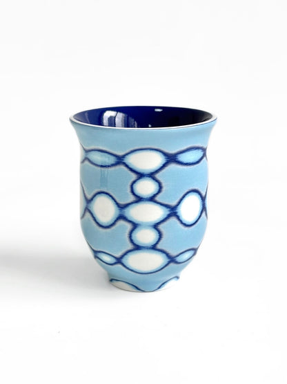 Light blue ceramic tea cup with navy blue interlocking circle outline pattern, TalkFun collection