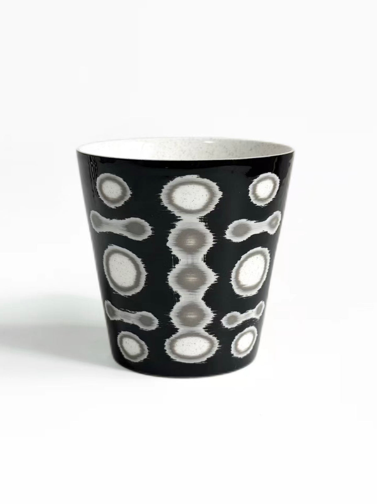 Black ceramic tea cup with grey and white circle pattern, tall tapered shape, TalkFun collection