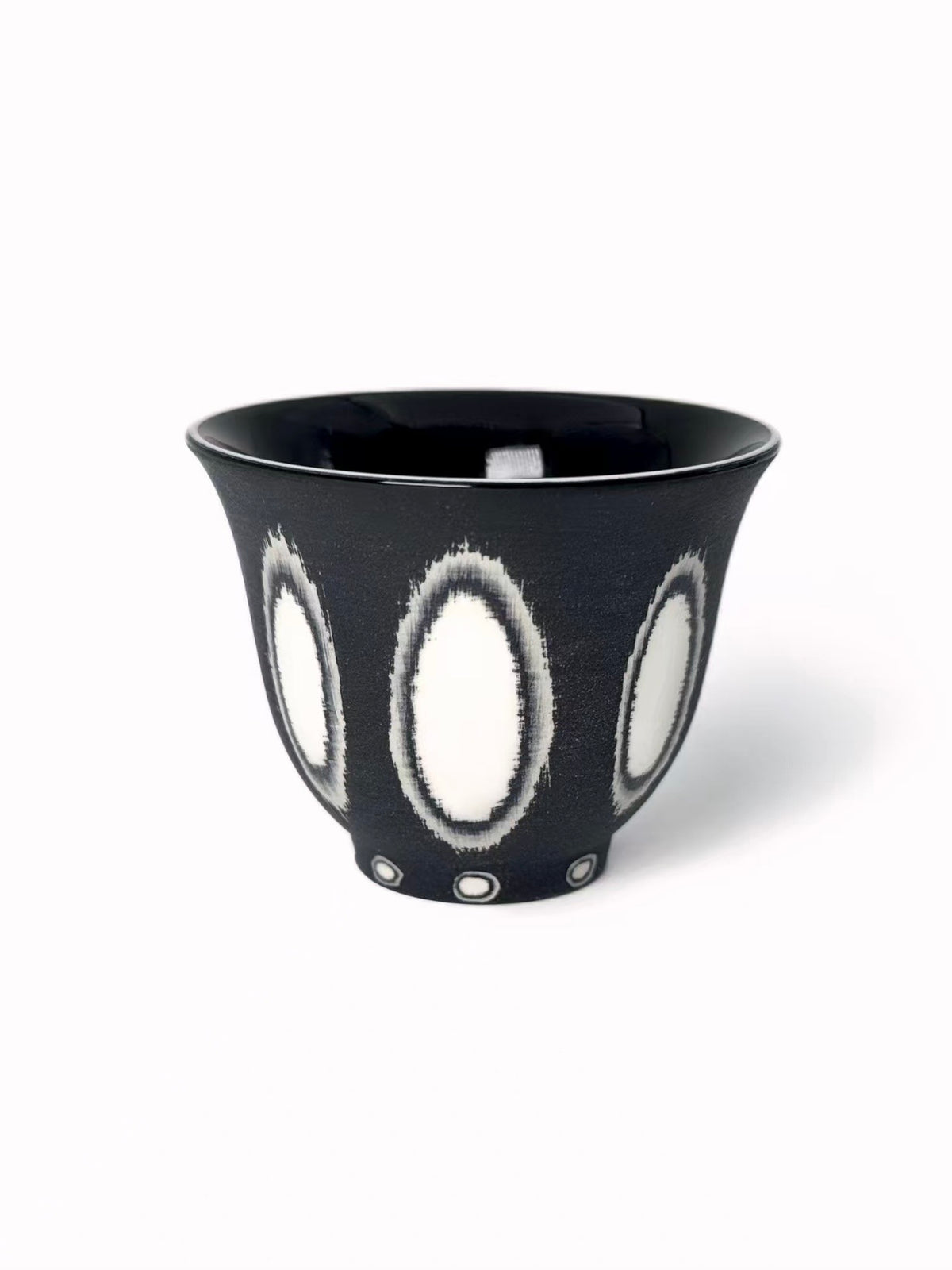 White ceramic tea cup with black oval pattern, tall tapered shape, TalkFun collection